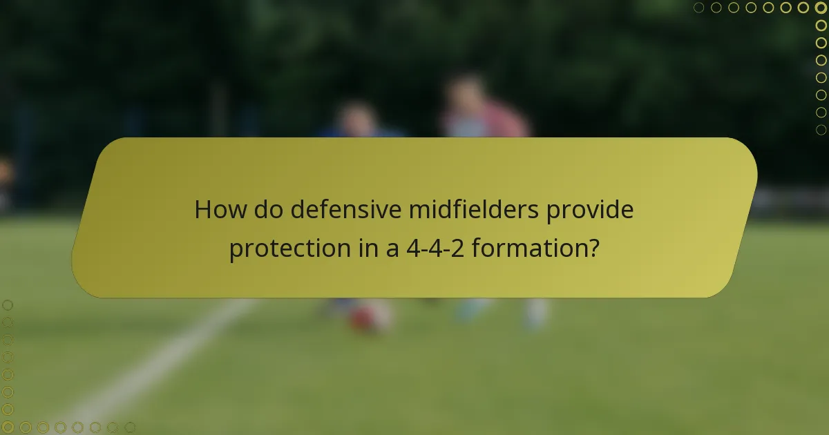 How do defensive midfielders provide protection in a 4-4-2 formation?